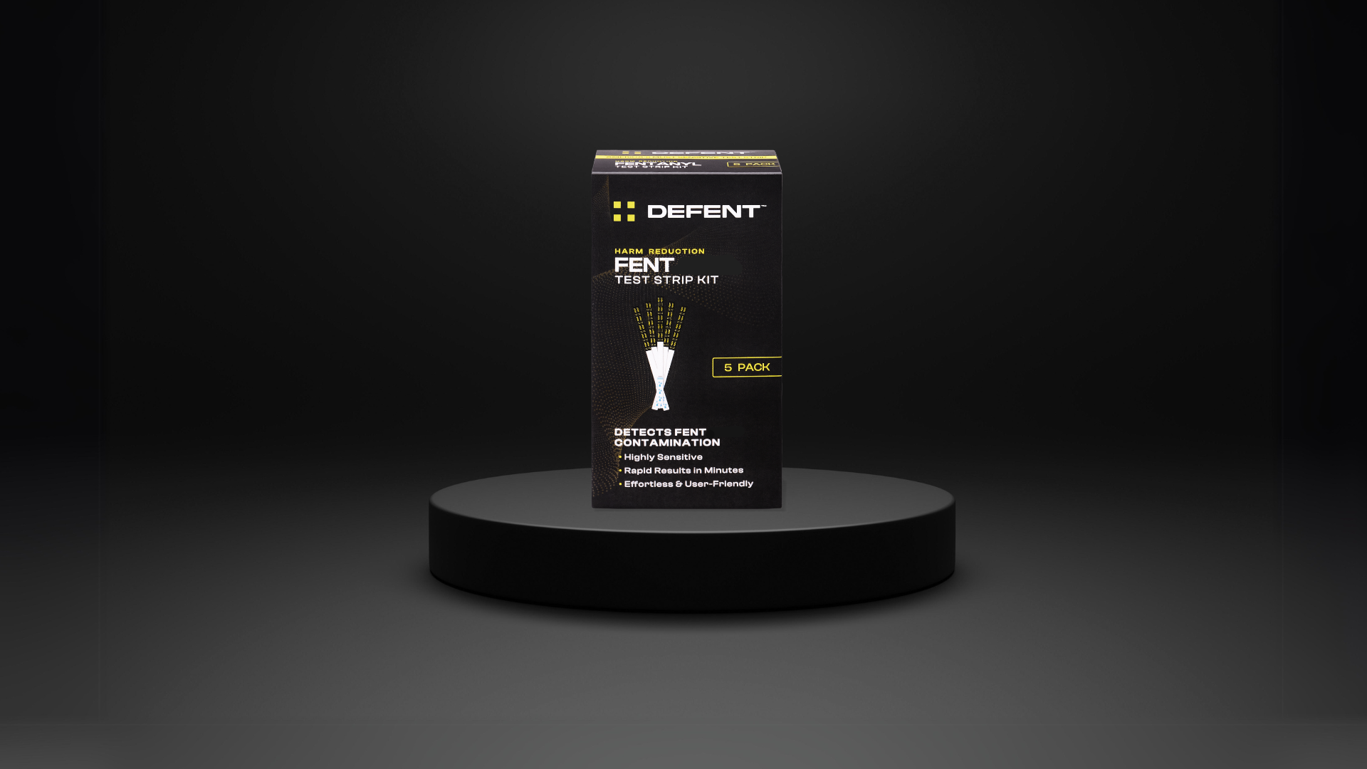 A black box labeled "DEFENT Fentanyl Test Strip Kit" displayed on a dark pedestal, emphasizing harm reduction and sensitivity.